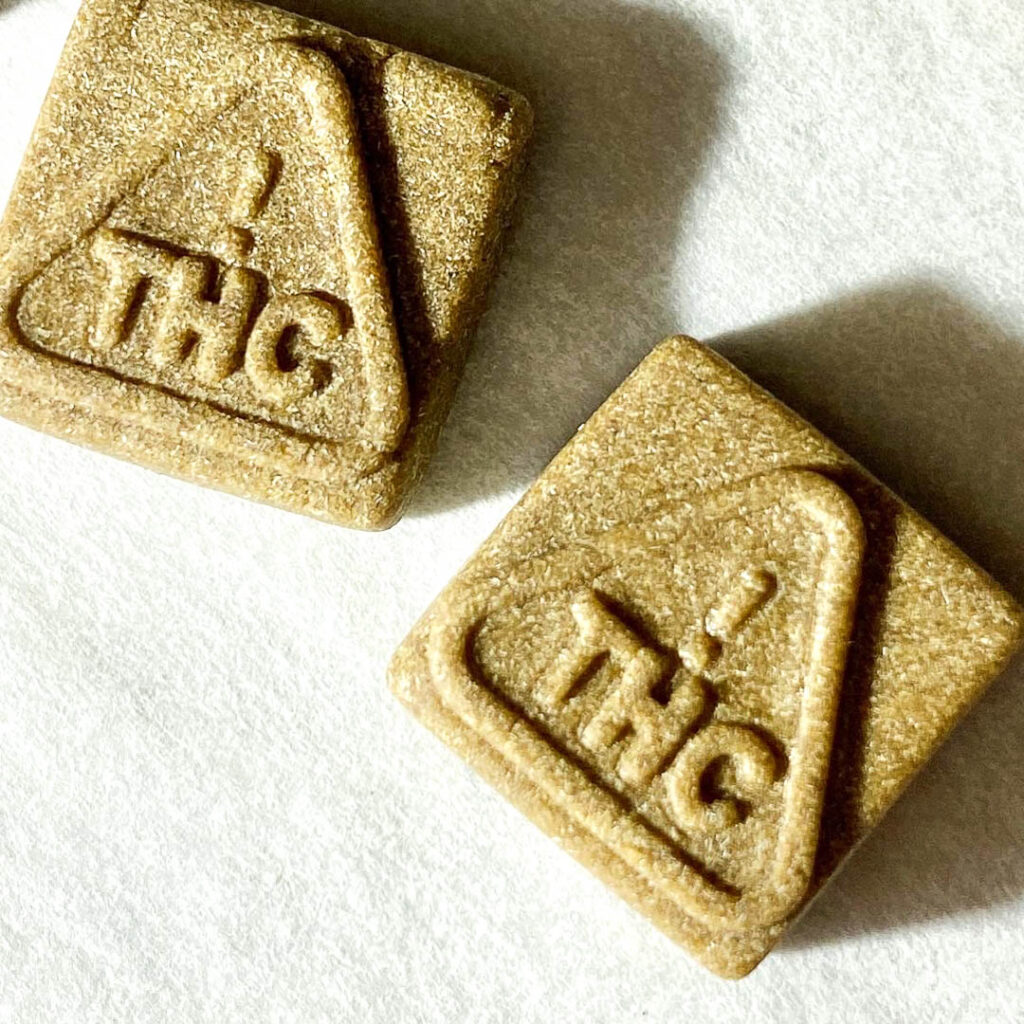A square object with a triangle on it that reads "THC"