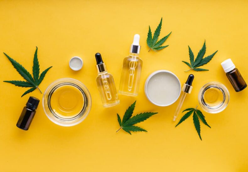 various cannabis products on a bright yellow background