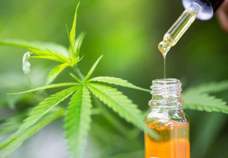 a close up image of high quality CBD oi with a green background