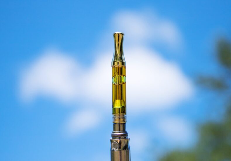 close up image of vape pen with sky in background